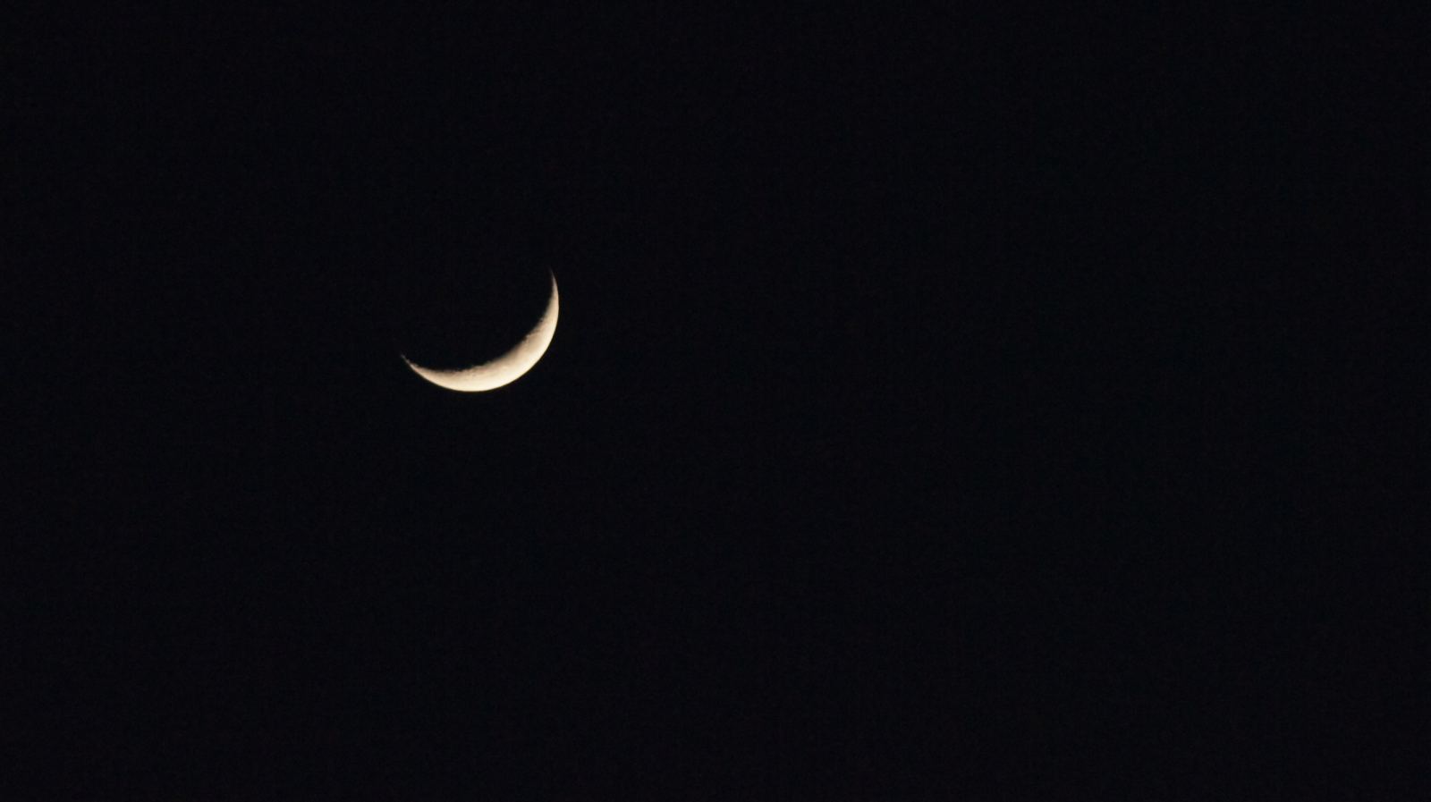 a crescent moon in a black sky